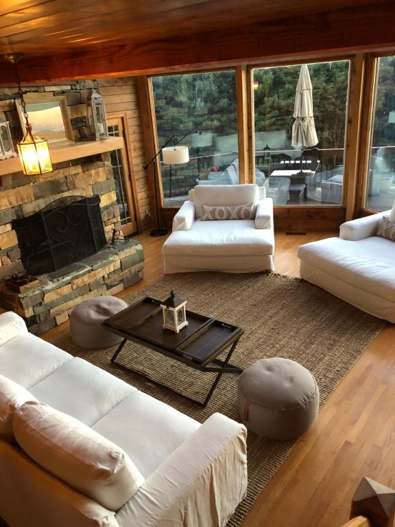 a living room with white furniture and a fireplace at Country vacation home 