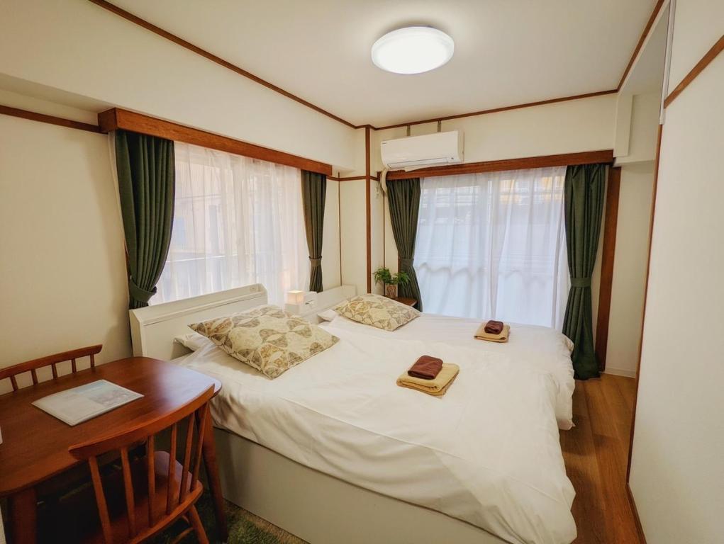 a bedroom with a white bed and a desk and window at Amber Iidabashi - Vacation STAY 89899v in Tokyo