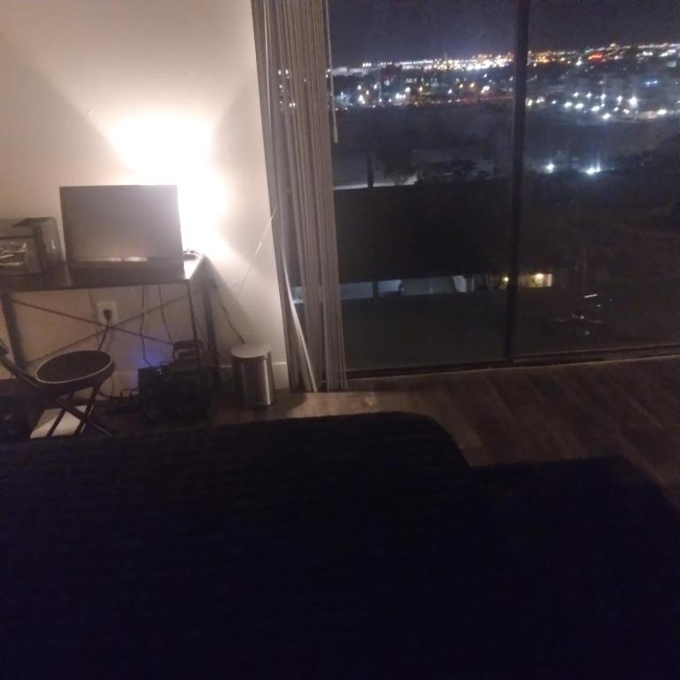 a room with a large window with a view of a city at Lovely high-rise steps away from the action in Las Vegas