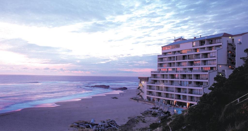 a hotel on the beach next to the ocean at Inn at Spanish Head Resort Hotel in Lincoln City