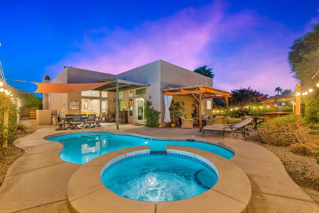 a home with a swimming pool in the backyard at A Royal Oasis in the Desert with pool, spa and Epic Game Room! in Bermuda Dunes
