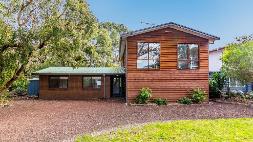 a home with a wooden house with a yard at Florida Tree's in Inverloch
