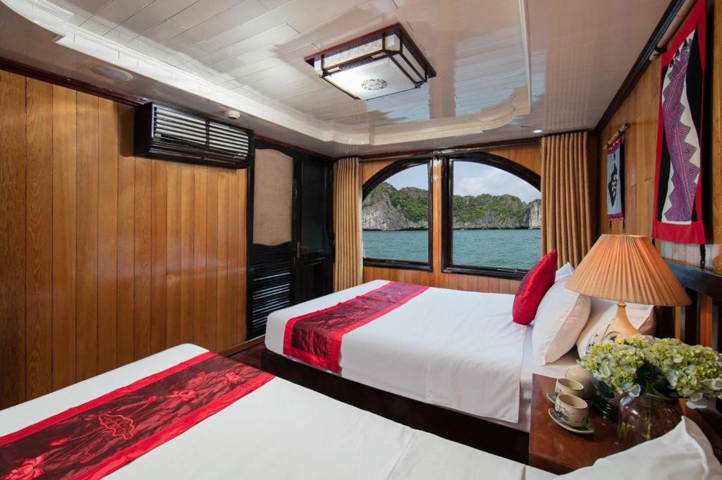 a bedroom with two beds on a boat at Cat Ba Boat - Private Boat in Cat Ba