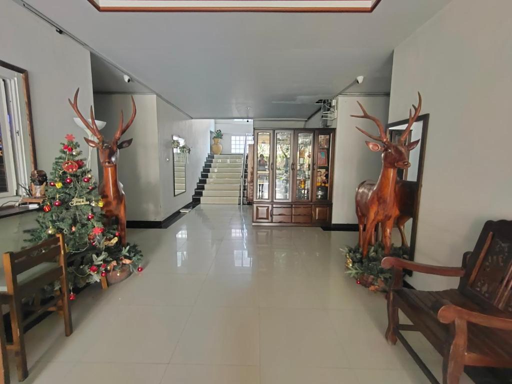 a hall with a christmas tree and reindeer decorations at The Rich Room ห้องพักนครราชสีมา in Ban Pra Dok