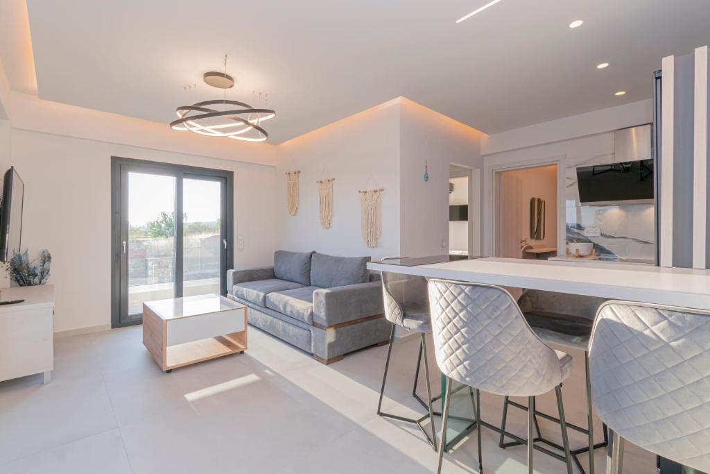 a kitchen and living room with a bar and a couch at SithoniaRS Melora Luxury Apartment in Nikiti