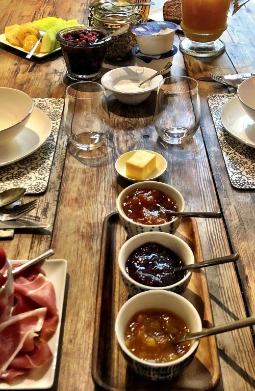 a wooden table with bowls of food on it at Maison Marie in Lagarde