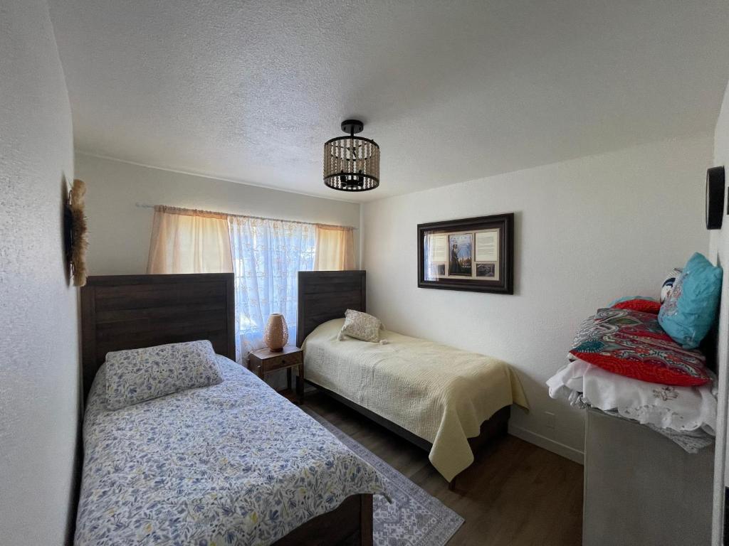 a bedroom with two beds and a window at Cozy House With Great Backyard in Frazier Park