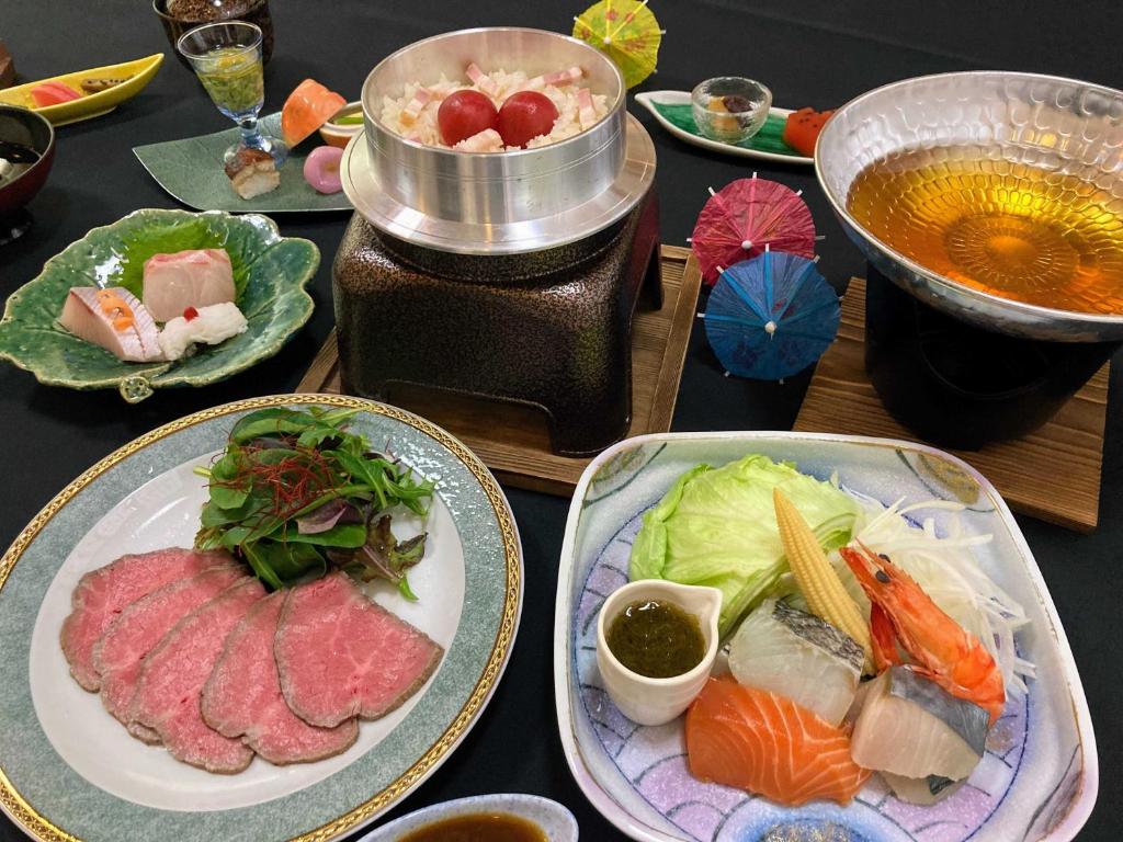 una mesa con platos de comida y un tazón de sopa en The Gran Resort Amanohashidate en Miyazu