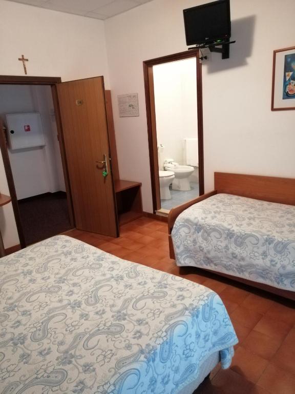 Postel nebo postele na pokoji v ubytování Hotel Trifoglio