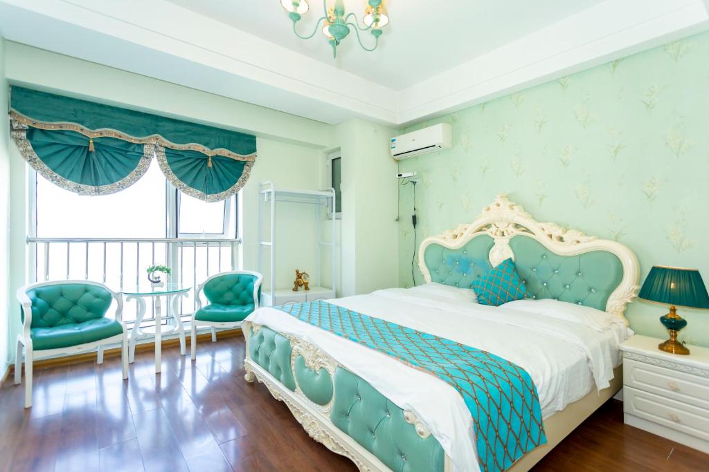 Postel nebo postele na pokoji v ubytování Dalian Hong Xi Yuan Apartment Wanda Plaza