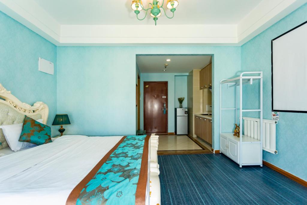 Postel nebo postele na pokoji v ubytování Dalian Hong Xi Yuan Apartment Wanda Plaza