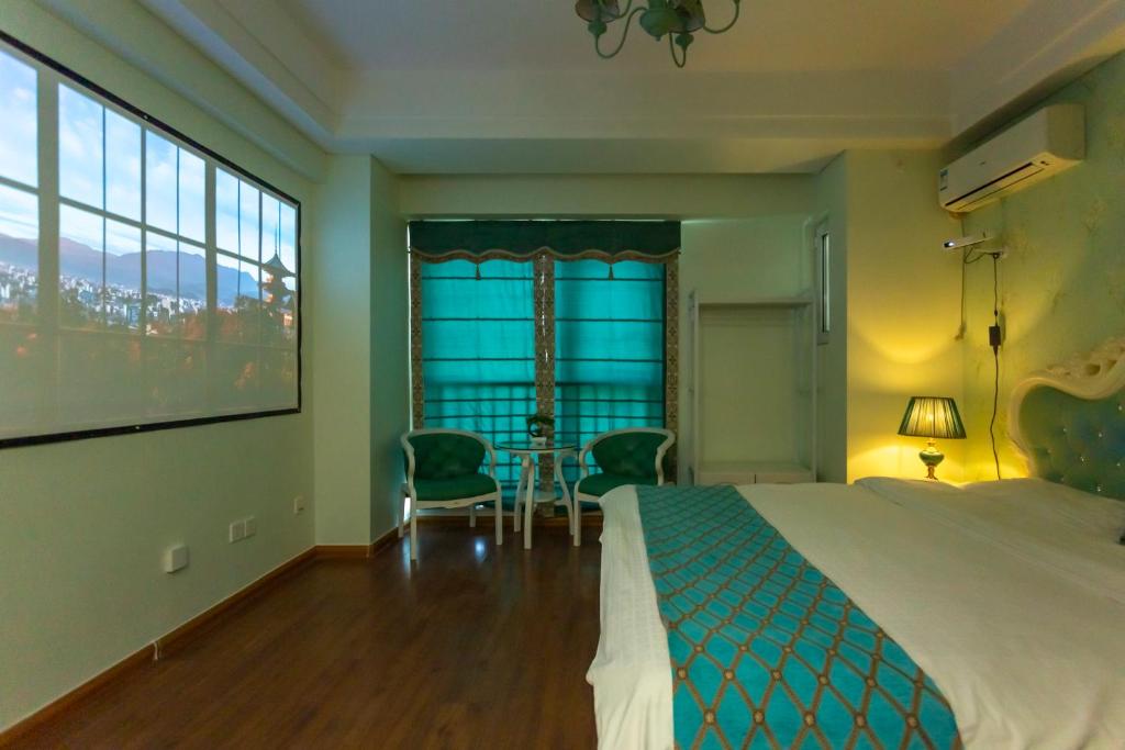 Postel nebo postele na pokoji v ubytování Dalian Hong Xi Yuan Apartment Wanda Plaza