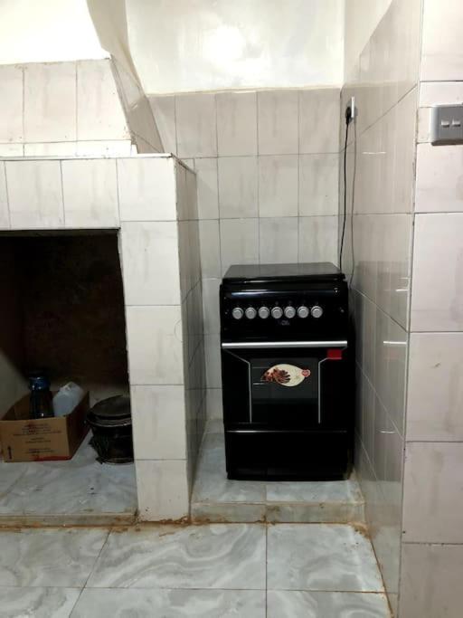 a kitchen with a black stove in a room at Aberdare Home in Othaya