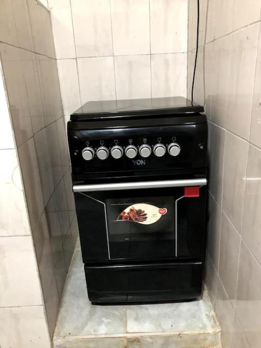 a black oven with a turkey on it in a kitchen at Aberdare Home in Othaya