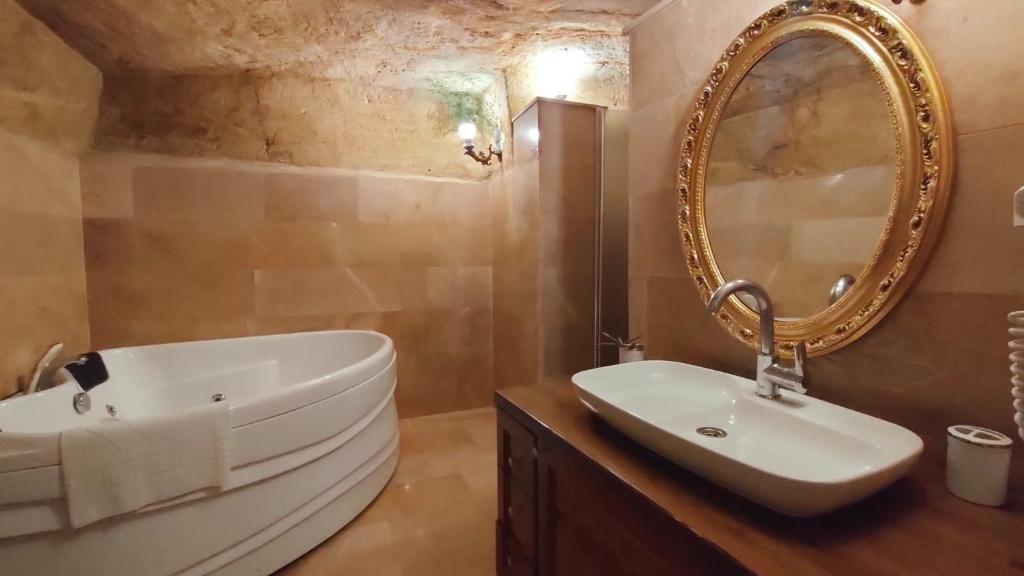 uma casa de banho com um lavatório branco e um espelho. em Ürgüp Inn Cave Hotel em Ürgüp