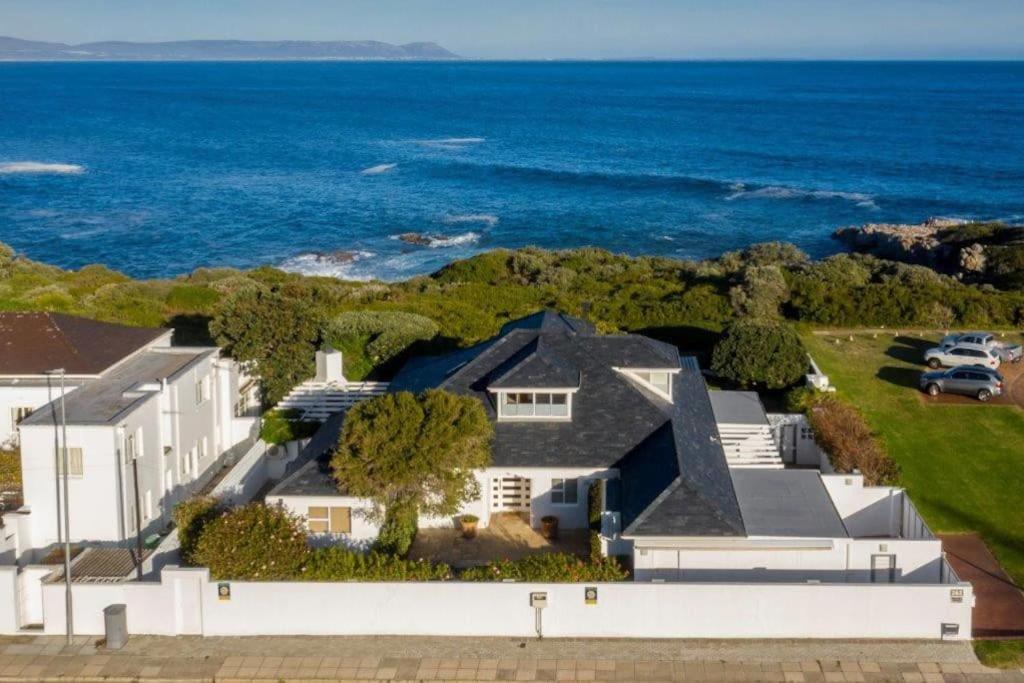 an aerial view of a house with the ocean at Wild Waters at Kraal Rock on the cliffs in Hermanus in Hermanus