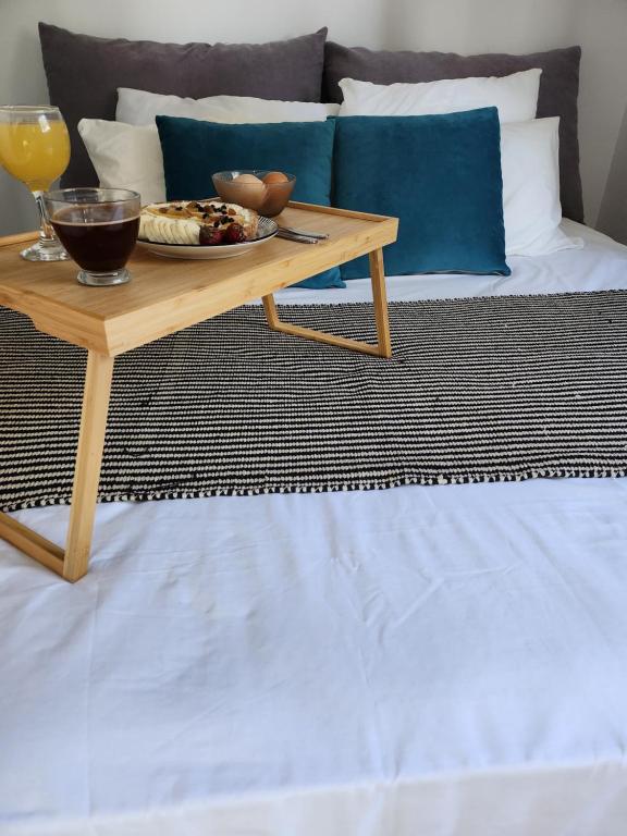 - une table basse avec une assiette de nourriture sur le lit dans l'établissement Serenita verde Apartment, à Poros