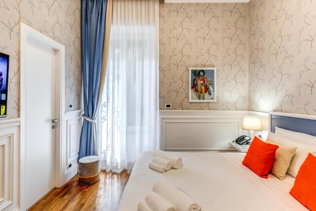 Postel nebo postele na pokoji v ubytování Mangili Garden Hotel