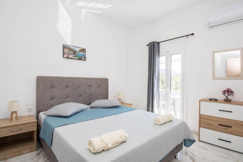 Postel nebo postele na pokoji v ubytování Zervakis Apartments