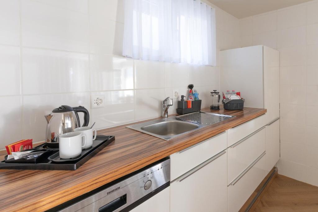 a kitchen with a sink and a counter top at Hotel Central in Engelberg