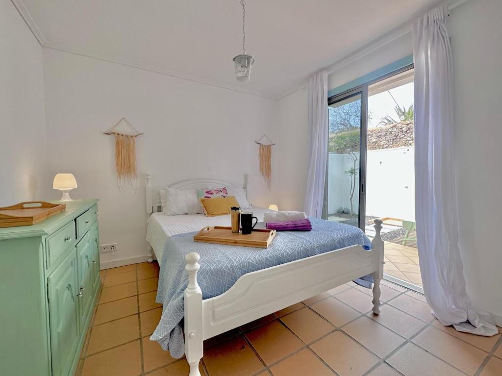 a bedroom with a bed with a tray on it at Casa bamboo in Porto Santo