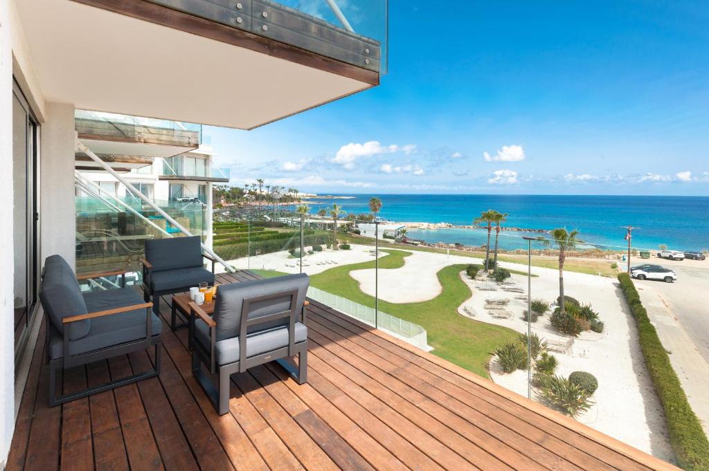 a balcony with chairs and a view of the ocean at Apartment Marisol - Beachfront in Protaras