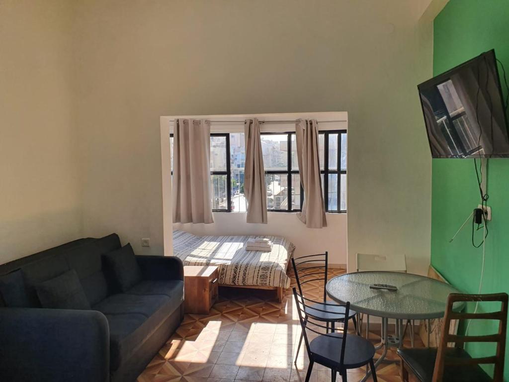 a living room with a couch and a table at Apartments BU93 in Tel Aviv