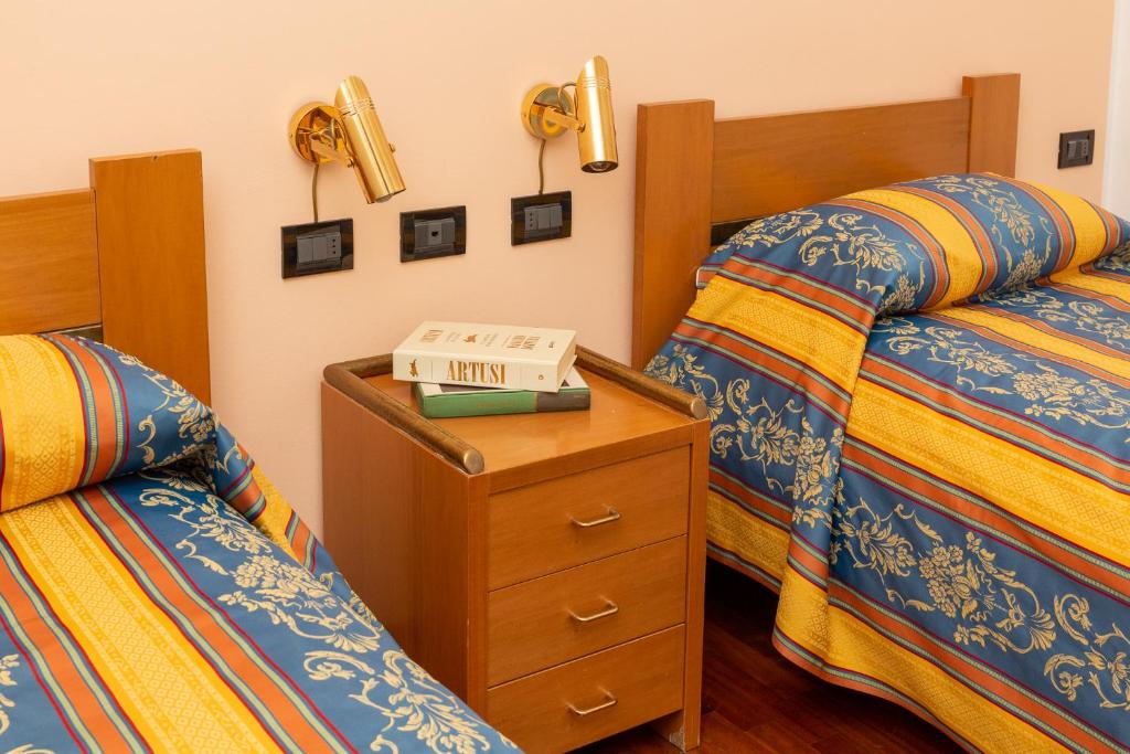 Postel nebo postele na pokoji v ubytování Albergo Sacro Monte Varese