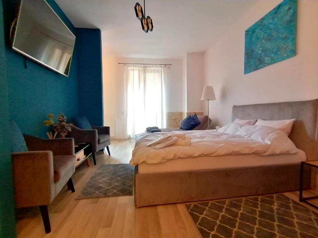 um quarto com uma cama, uma cadeira e um sofá em Belvedere Studio em Brasov