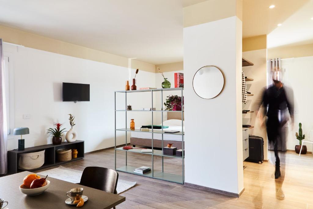 a living room with a glass door leading to a bedroom at MAR Modena Accommodation in Residence in Formigine