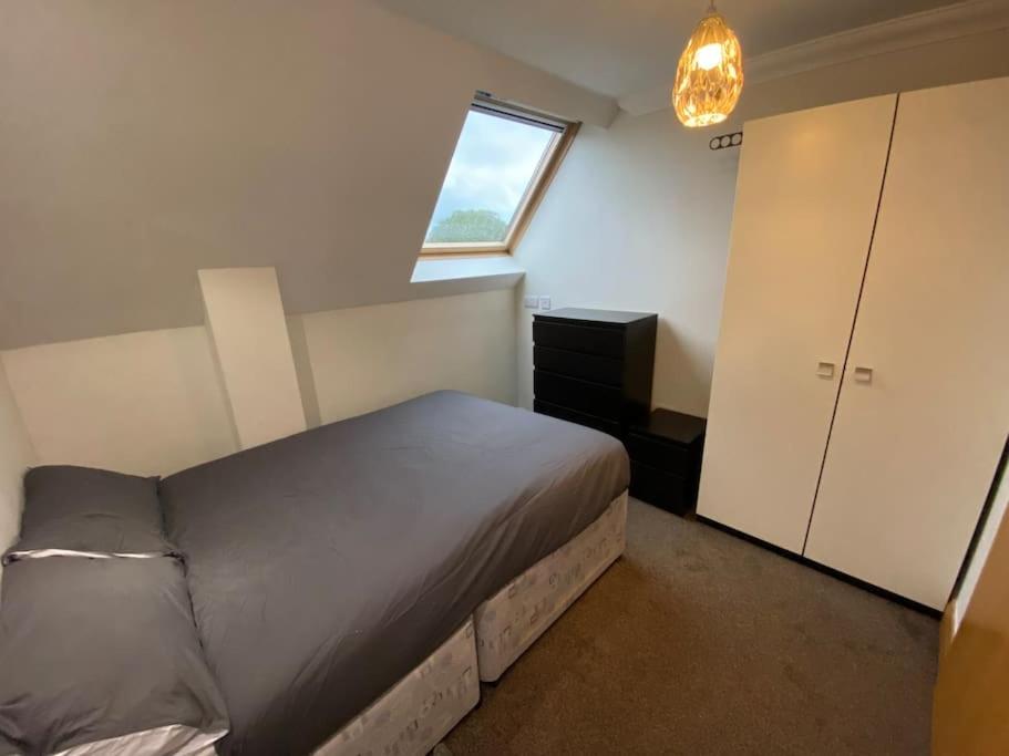 a small bedroom with a bed and a window at spacious 2 bed apartment in Norwich city centre in Norwich