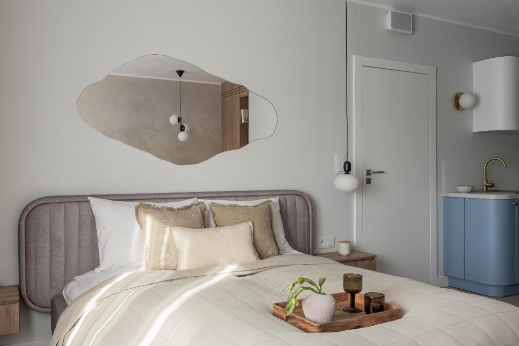 a bedroom with a bed with a tray on it at Flatbook - City Center Apartments Dwie Motławy in Gdańsk