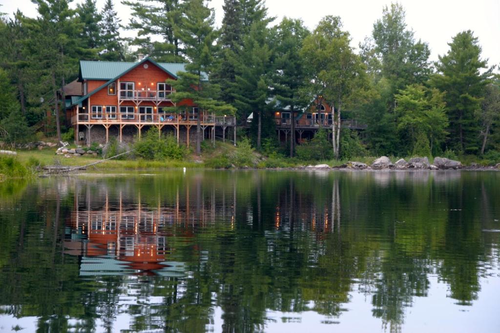 a large house on the shore of a lake at Sunny Rock Bed & Breakfast in Minden