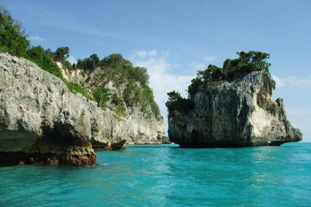 a group of rocks in the water near the ocean at Suites la Colline in Cacor