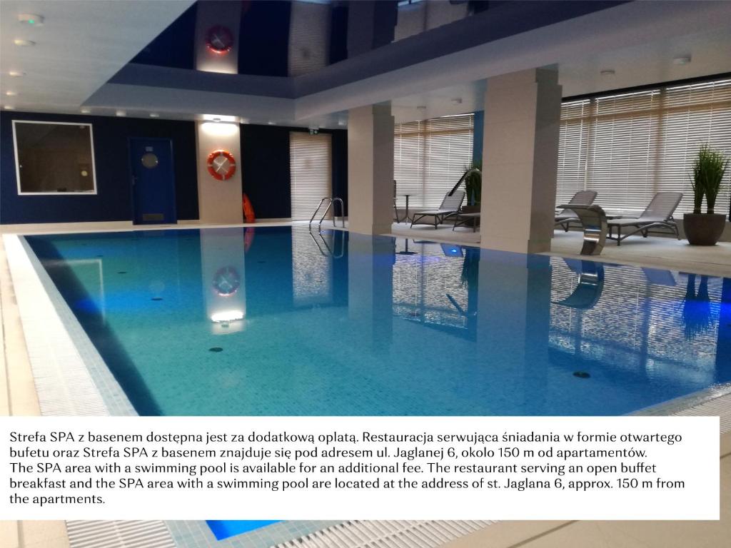 a large swimming pool in a building at Flatbook - City Center SPA Apartments Toruńska in Gdańsk