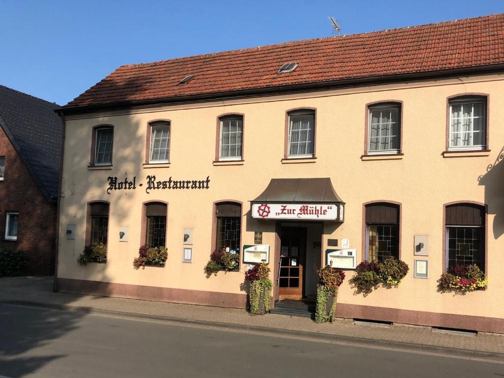 ein Gebäude an der Straßenseite in der Unterkunft Hotel-Restaurant Zur Mühle in Schermbeck