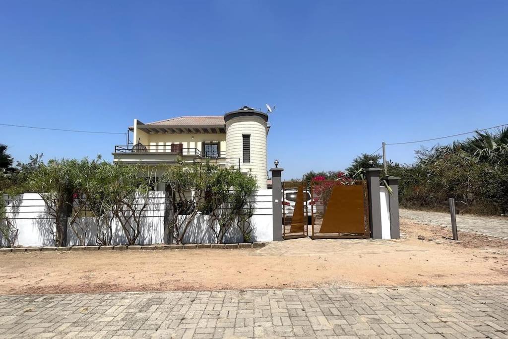 a white house with a fence and a gate at Rosa Parks Villa - Sanyang The Gambia in How Ba