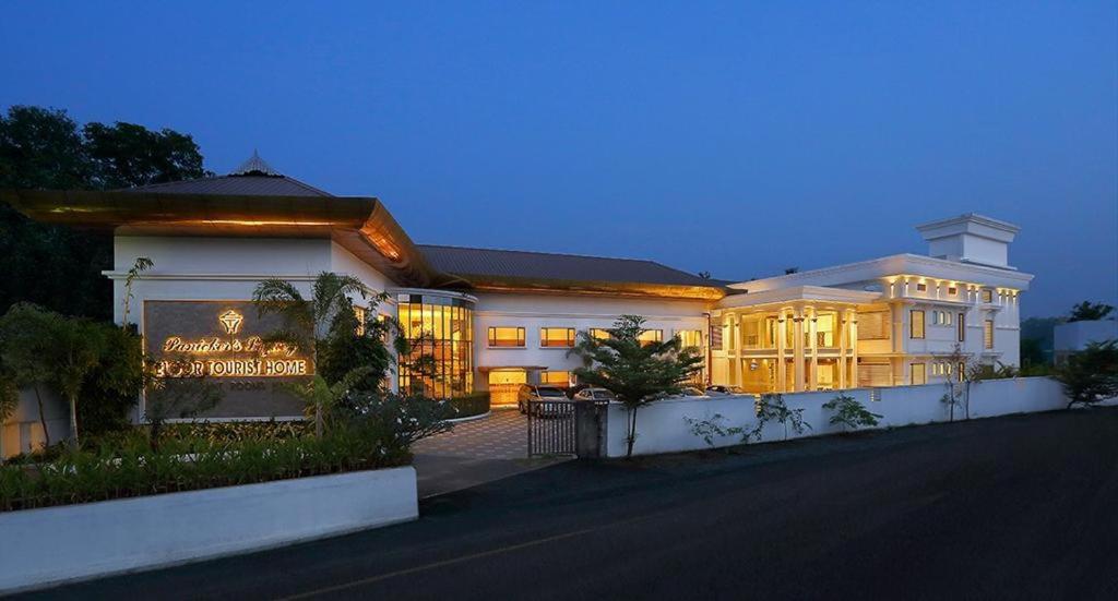 a large white building with lights on it at Eloor Tourist Home in Ernakulam