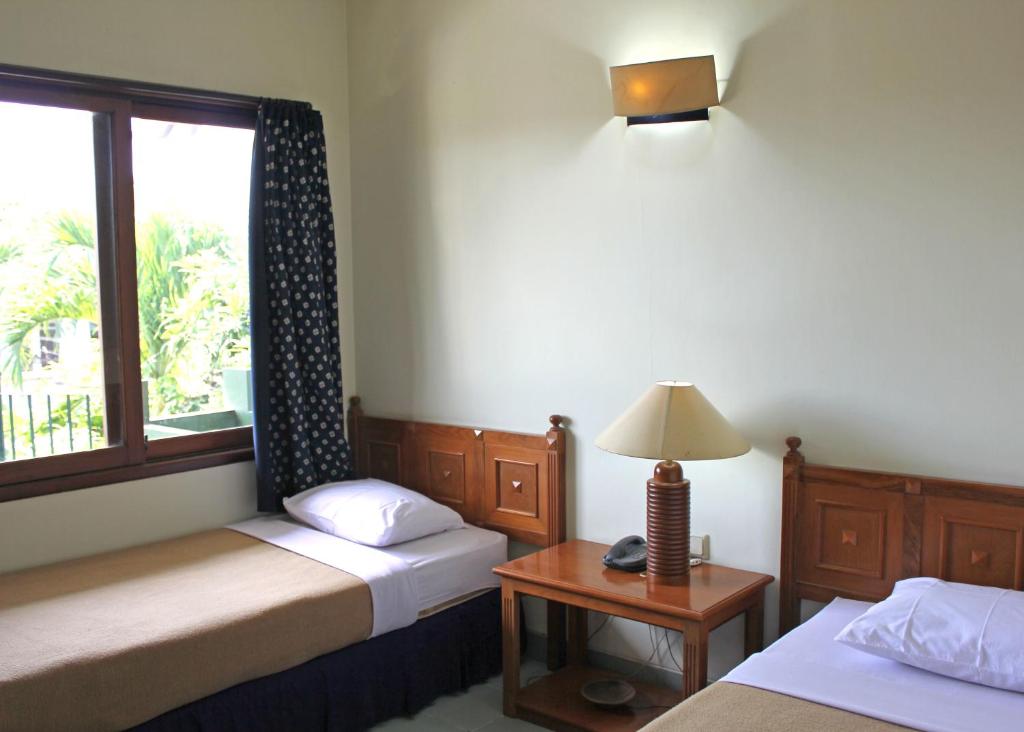 Postel nebo postele na pokoji v ubytování Hotel Winotosastro Garden