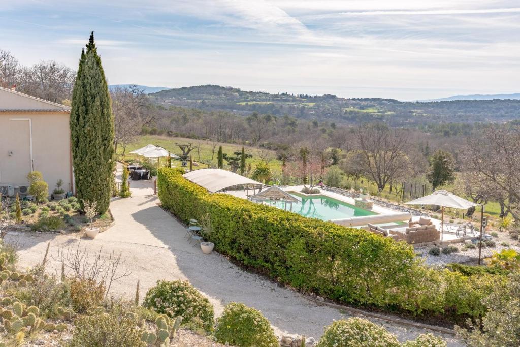 an estate with a swimming pool and a garden at Bastide Rocquejeanne in Murs