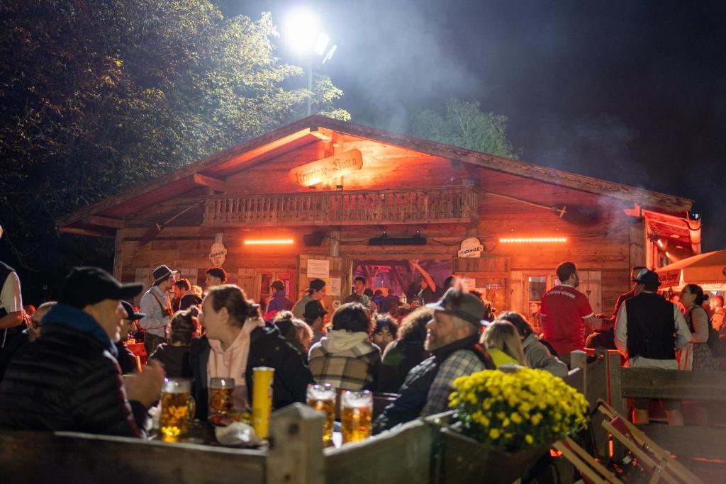 a crowd of people sitting in front of a bar at Wies'n Camp in Munich