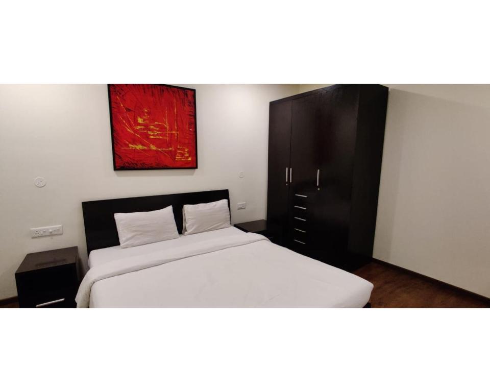 Кровать или кровати в номере Aarju Luxurious Stay Calangute