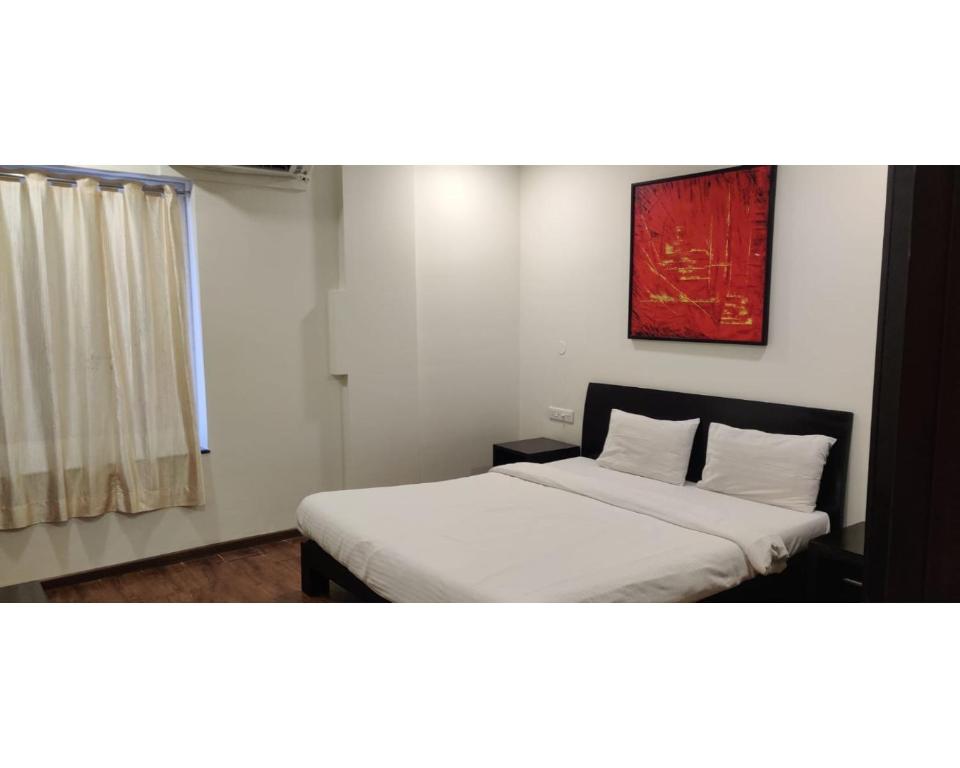 Кровать или кровати в номере Aarju Luxurious Stay Calangute