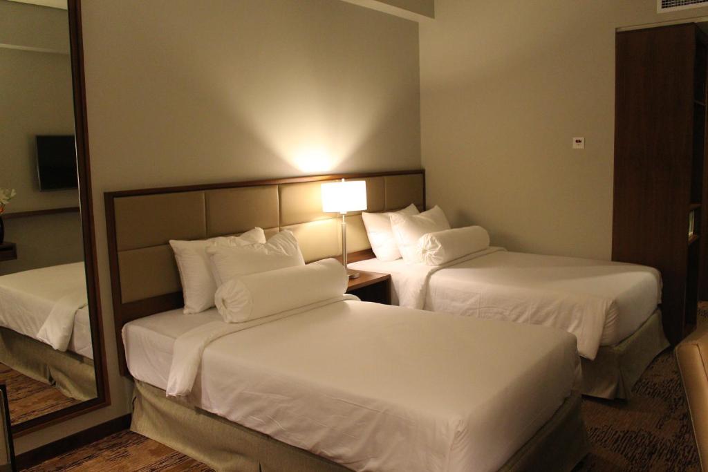 Postel nebo postele na pokoji v ubytování I Hotel Baloi Batam