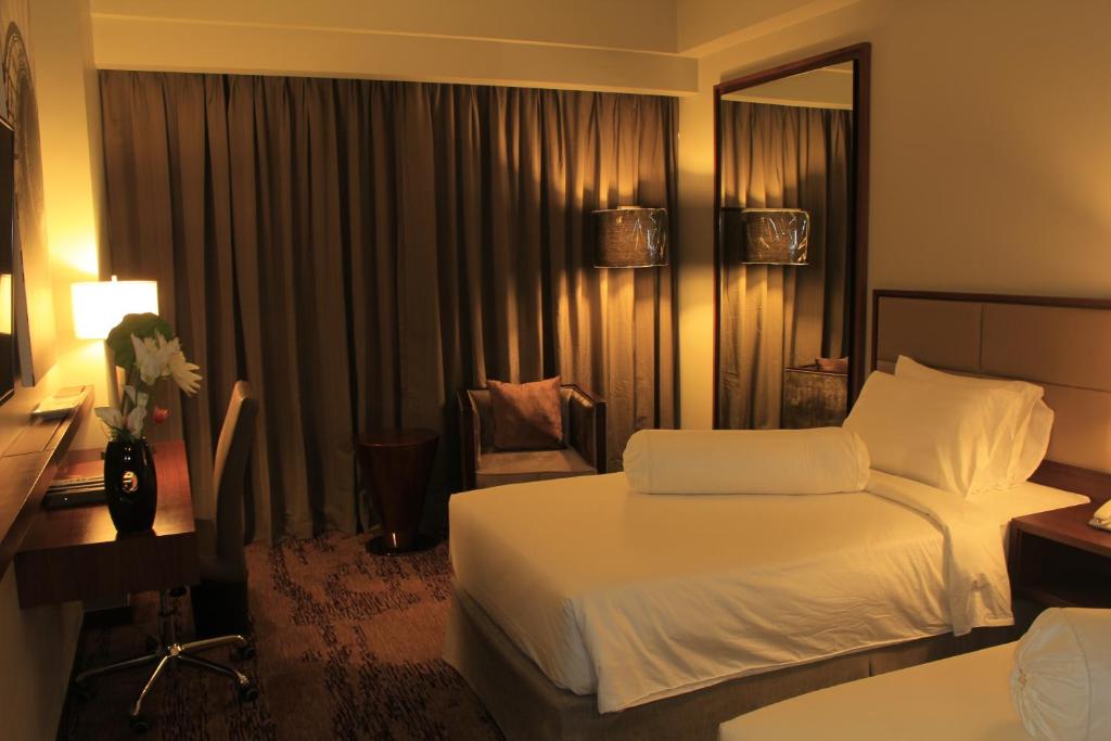 Postel nebo postele na pokoji v ubytování I Hotel Baloi Batam