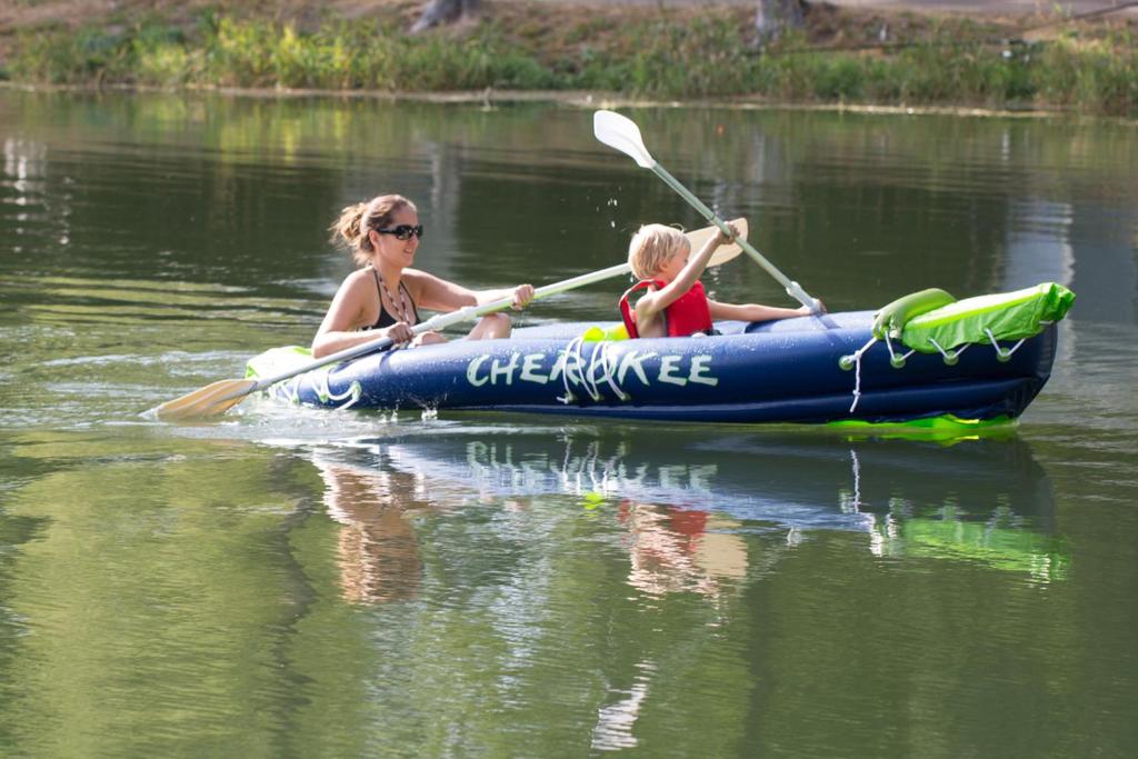 a woman and a child in a raft on the water at Country Camp camping Domaine des Messires in Herpelmont