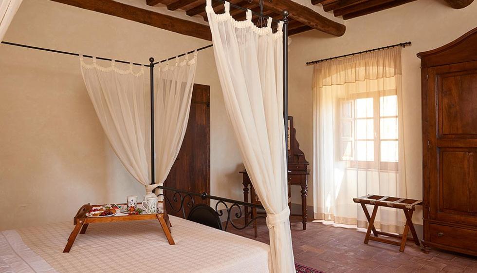 Postel nebo postele na pokoji v ubytování Hotel Relais Palazzo di Luglio