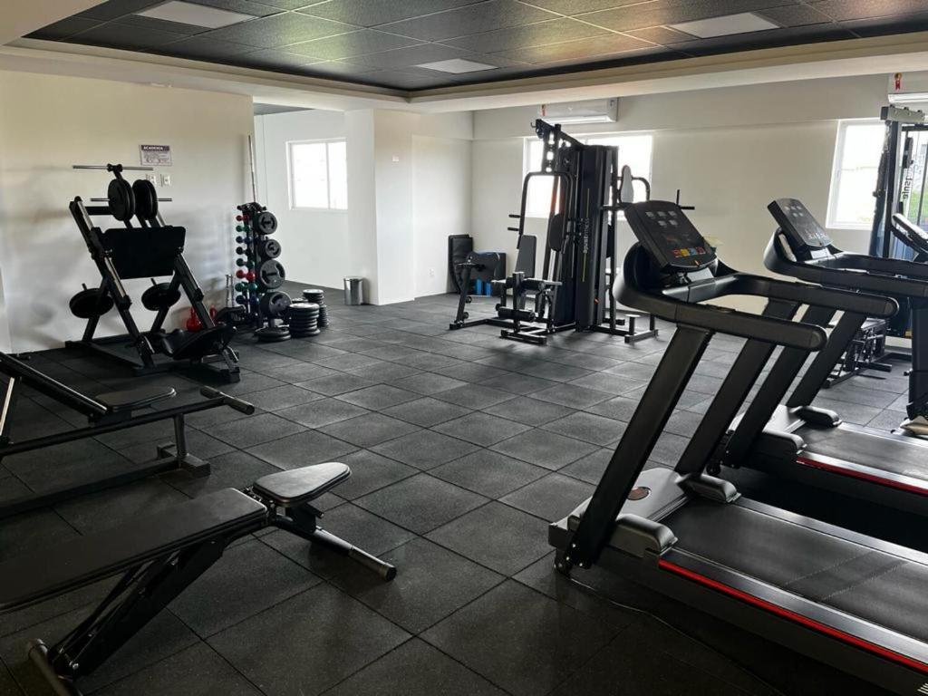 a gym with several tread machines in a room at Studio Novo no West Fit Mossoró in Mossoró