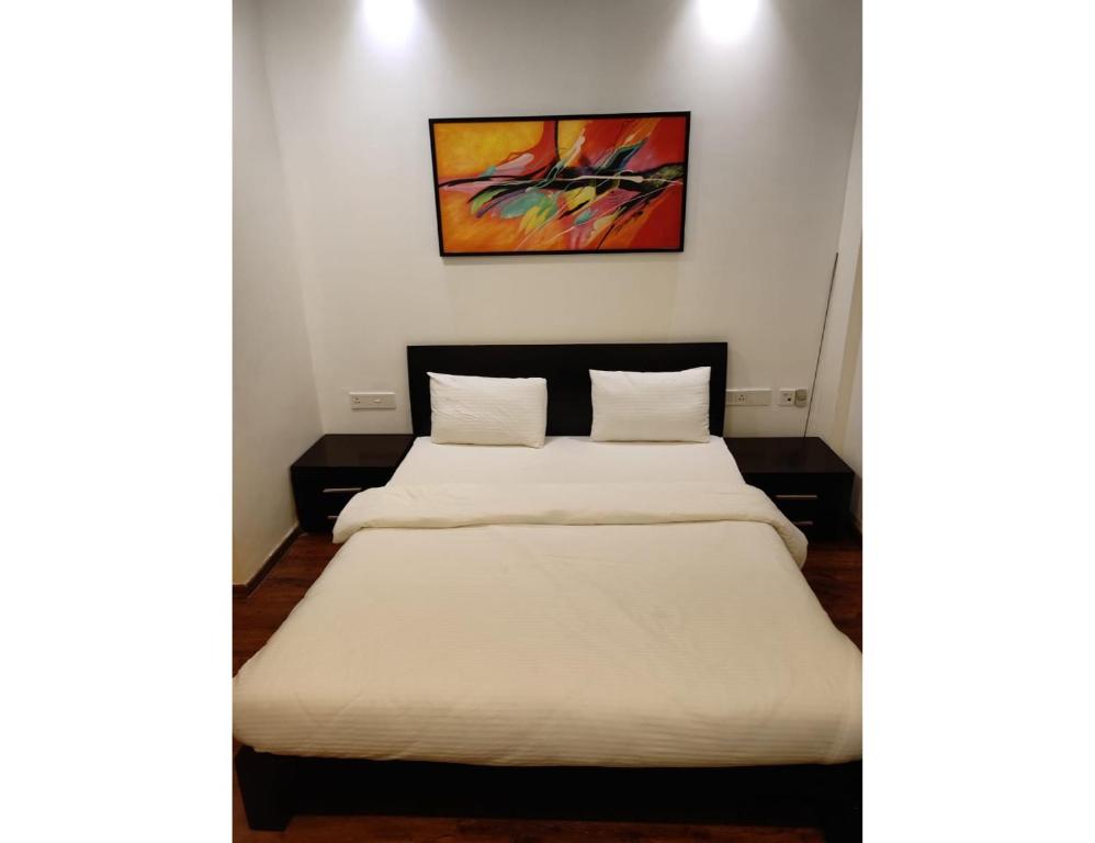 Кровать или кровати в номере Aarju Luxurious Stay Calangute