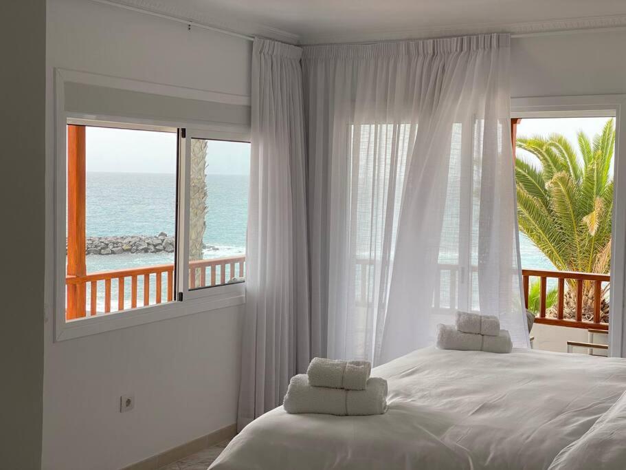 a bedroom with a bed with a view of the ocean at Villa Tranquila, Playa del Duque in Adeje
